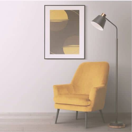 A minimalist living space featuring a yellow armchair, a floor lamp, and abstract wall art in an Omaha salon.