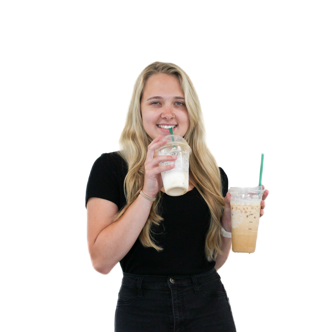 A woman with long blonde hair, wearing a black shirt, holds two iced beverages in clear cups with green straws, smiling at the camera.