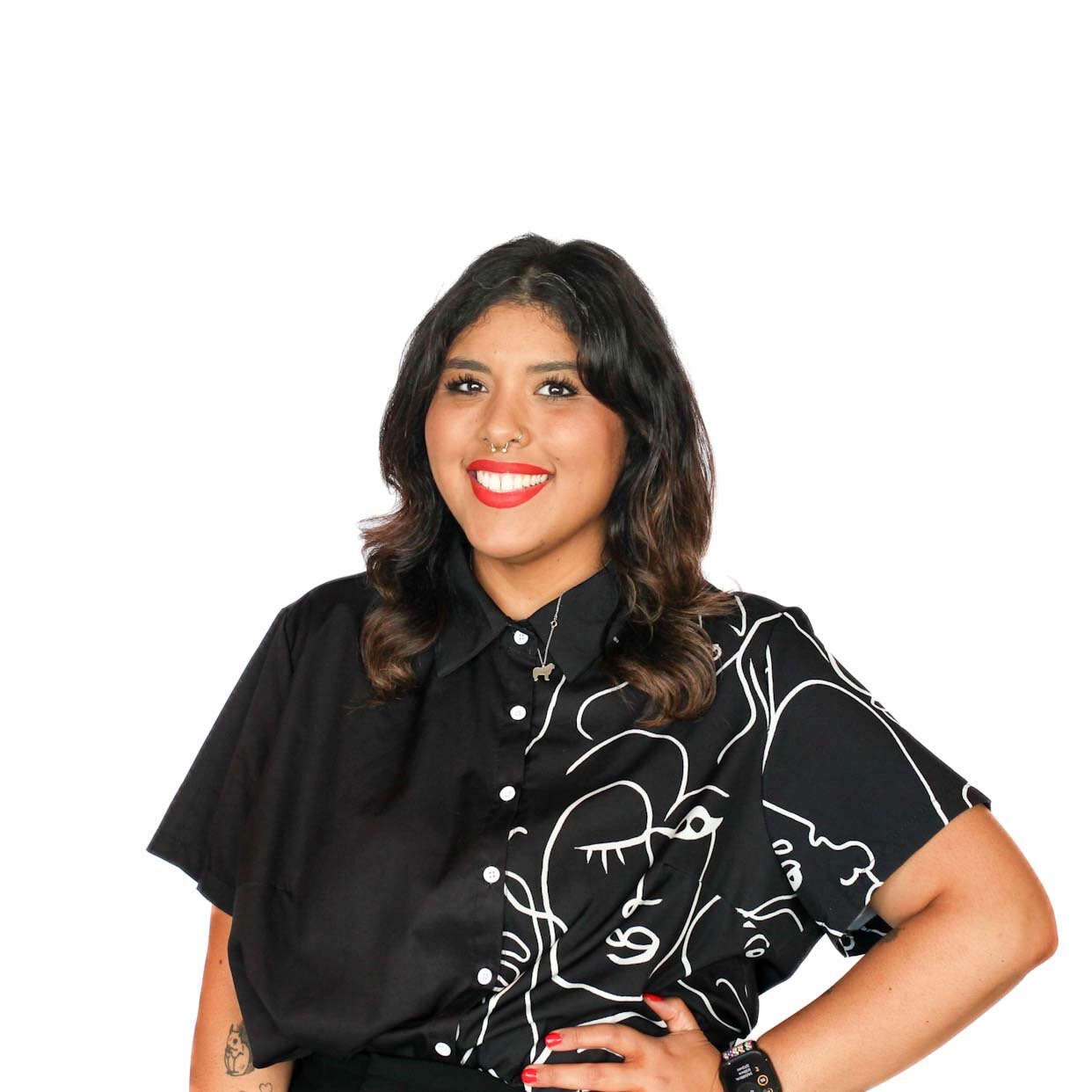 A smiling woman wearing a black short-sleeved shirt with a white line-art illustration.